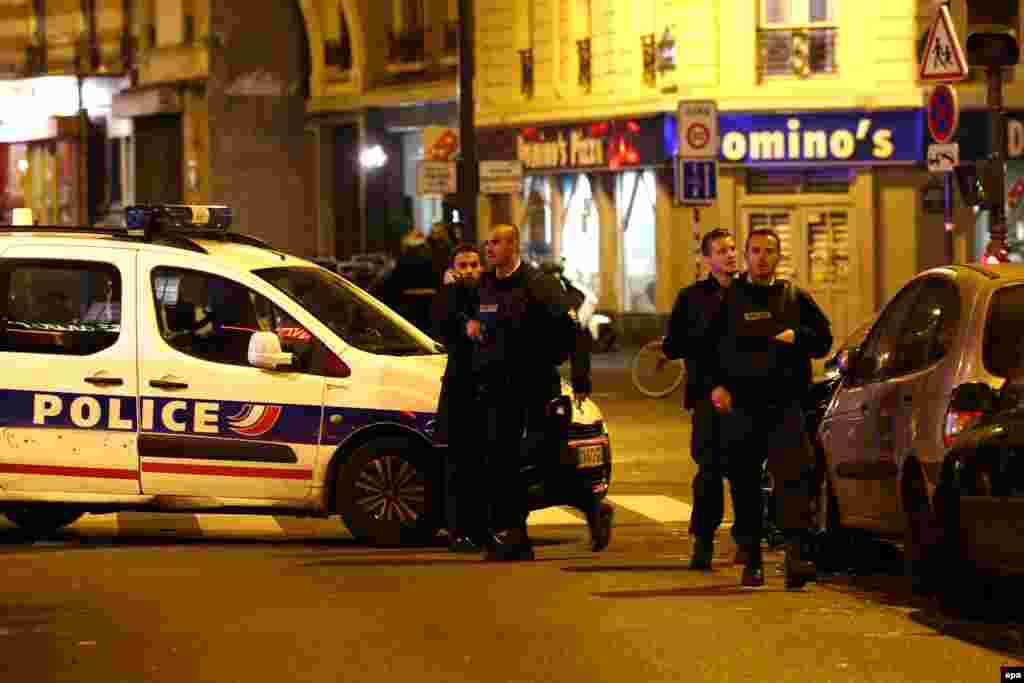 Police officers arrive at the scene of one of the fatal shootings in Paris on November 13.