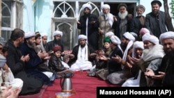 Sufi leader Abdul Waheed Bahaduri (center) prays in a mosque in Kabul.