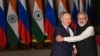 Indian Prime Minister Narendra Modi (right) greets Russian President Vladimir Putin before a meeting at Hyderabad House in New Delhi on December 6, 2021.