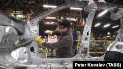 A worker assembles a new model at the Nissan plant in outside St. Petersburg.