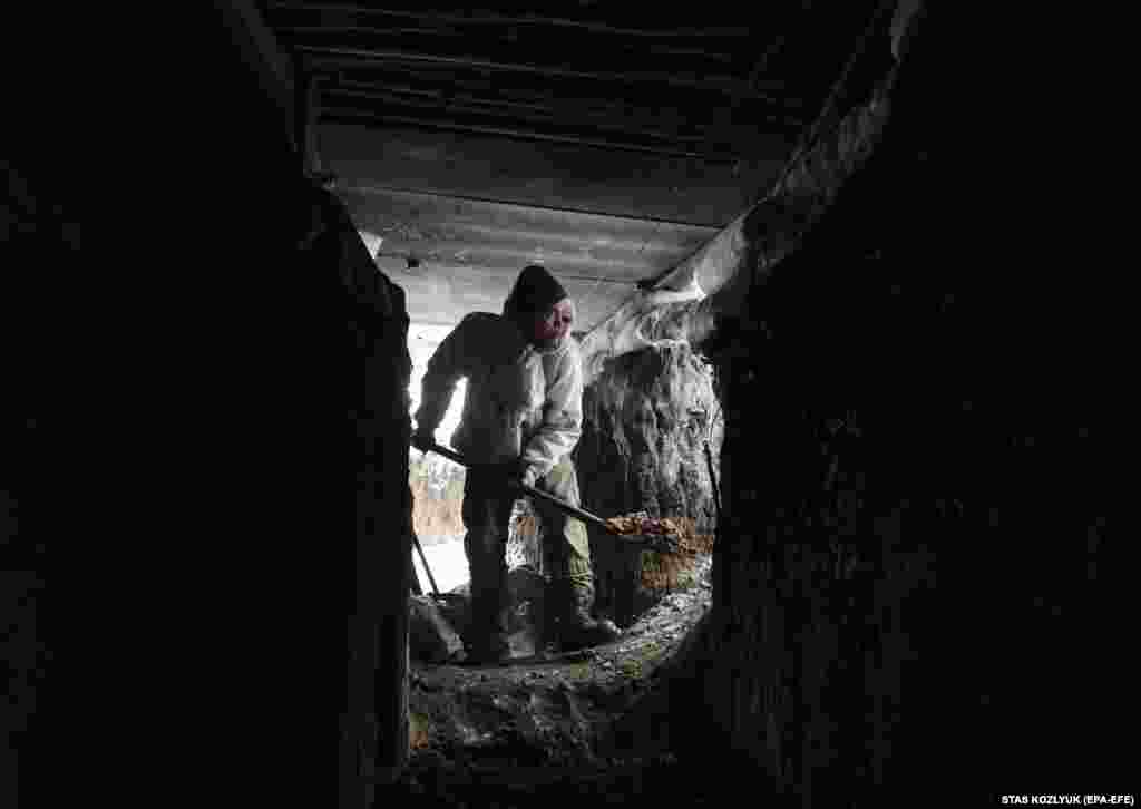 A soldier repairs a trench near Donetsk.