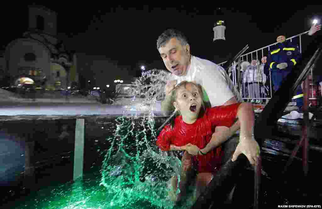 A young girl reacts to the icy waters in Krasnogorsk, near Moscow.&nbsp;