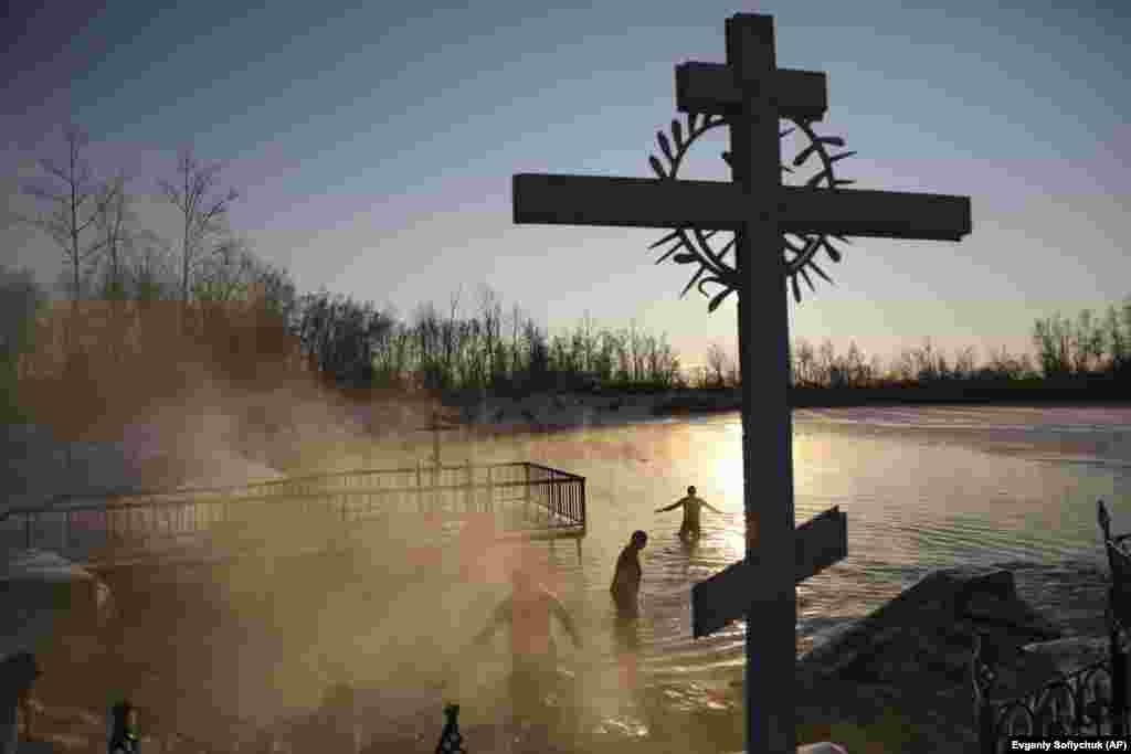 People bathe in temperatures that dropped as low as -14 degrees Celsius near the Achairsky monastery outside the Siberian city of Omsk, Russia, during Epiphany celebrations on January 19. Many Orthodox Christians around the world have been marking the Epiphany, one of the faith&#39;s three biggest celebrations.