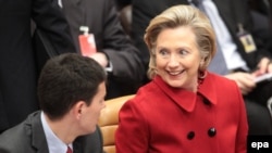 U.S. Secretary of State Hillary Clinton speaks with her British counterpart David Miliband at the NATO meeting in Brussels.