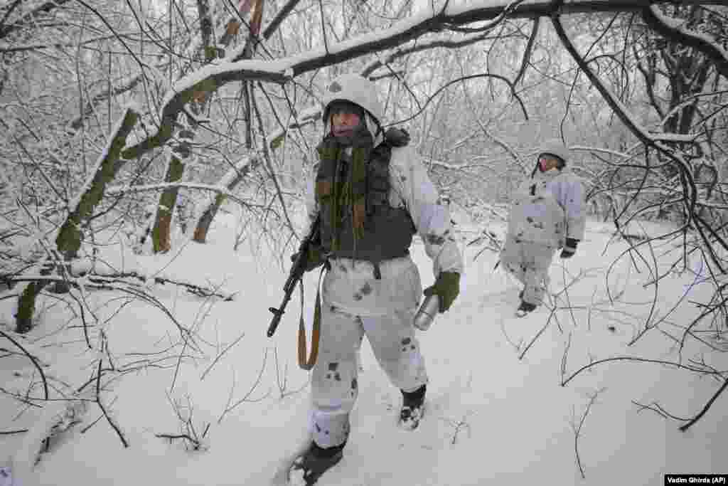 A Ukrainian soldier wearing winter camouflage walks to an outpost in the Luhansk region.