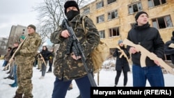 Several hundred people -- mostly men, many in camouflage or all-black clothing -- underwent civil-defense training on the grounds of an abandoned heavy machinery factory on Kyiv’s western outskirts.