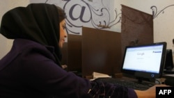 A woman surfs the Internet at a cybercafe in central Tehran.