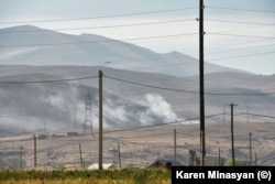 Smoke and dust from shelling rises near Sotk on September 14.