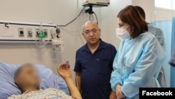 Armenian Health Minister Anahit Avanesian (right) visits civilians wounded by Azerbaijani shelling on September 14. 