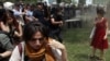 In a photo adopted by protesters as a symbol of their struggle, a Turkish policeman uses tear gas against a woman during a rally in Taksim Square in central Istanbul on May 28.