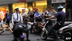 Photographers gather as an Occupy Wall Street protester is detained near Zuccotti Park in New York City on October 14.