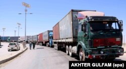 Trucks carrying supplies for NATO's Resolute Support mission wait for clearance on Pakistan's border with Afghanistan in June.