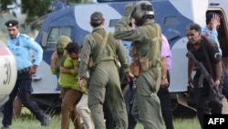 Pakistani security personnel move Rimsha Masih, a young girl accused of blasphemy, to a helicopter after her release from jail in Rawalpindi.