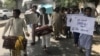 Afghan and Pakistani musicians play music and sing during a protest in Peshawar on May 30.