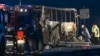 Firefighters, police, and investigators inspect the wreckage of the bus near the village of Bosnek, Bulgaria, on November 23.