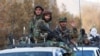 Taliban fighters sit on a vehicle during a military parade in Kabul. 