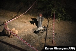 The tail section of a rocket embedded in a road near Jermuk on September 15.