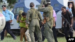 Pakistani security personnel move Rimsha Masih (second from left) to a helicopter after her release from jail in Rawalpindi on September 8.