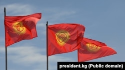 The current design of Kygyrstan's flag shows a yellow sun with a yurt-like opening against a red backdrop. (file photo)