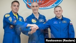 Chris Cassidy of NASA (left to right), Anatoly Ivanishin and Ivan Vagner of Roskosmos pose for a picture ahead of their mission to the International Space Station on April 8.