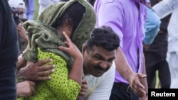 Security officials surround Rimsha Masih, a Christian girl who is thought to be 14 or so and with learning disabilities, as she's moved to a helicopter after her release on bail from Adyala jail in Rawalpindi on September 8.