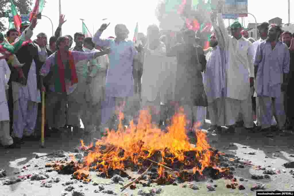 Protesters burn the U.S. flag.