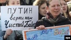 A woman holds a poster reading "Putin Give Us A Clean Baikal Back" during a demonstration in Moscow on March 28.