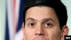 Britain's David Miliband demanded the release of the embassy staff