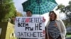 A woman holds a sign reading "You can't shut up everyone!" as journalists and supporters take part in a protest against the list of "foreign agent" media in central Moscow on September 4.