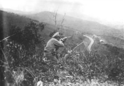 Ivan Kalmykov, a Cossack fighter allied with the Whites during the war, fires on an enemy position in Russia’s Far East.