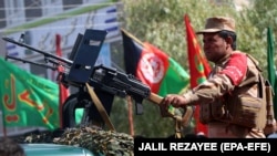 Afghan security officials secure the venue of a mourning procession ahead of Ashura in Herat on September 20.