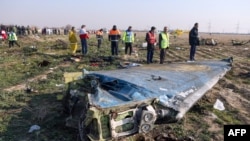 Rescue teams at the site where a Ukrainian airliner crashed in January after being shot down by Iranian defense forces. All 176 people on board the plane died in the incident. 