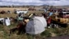 The two heads of the Statue Of Humanity lie in a municipal dump on the outskirts of Kars.