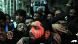 Images of killer Malik Mumtaz Hussain Qadri feted by supporters and garlanded with flowers in custody shocked critics of Pakistan's hard-line religious establishment.