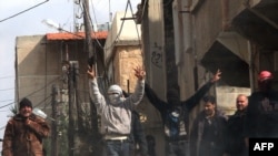 Antigovernment activists gather on the streets of Daraa on March 23.