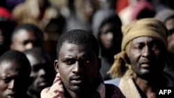 African refugees wait at a makeshift camp near the Libyan port city of Misurata on March 31.