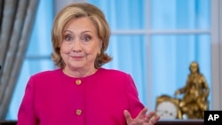 Former U.S. Secretary of State Hillary Clinton jokes with the audience during her speech at her portrait unveiling ceremony at the State Department in Washington on September 26.