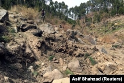 A Pakistani soldier near a crater allegedly left by an Indian air strike in Pakistan's Balakot region. Photo taken on February 28.