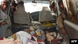 The bodies of Afghan civilians allegedly shot by a rogue U.S. soldier lay in the back of a van in Alkozai village.