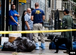 Mohammed Rahami (third from left), the father of Ahmad Khan Rahami, talks with FBI investigators in Elizabeth, New Jersey.