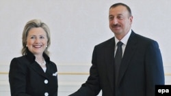 U.S. Secretary of State Hillary Clinton (left) shakes hands with Azerbaijani President Ilham Aliyev during their meeting in Baku today.