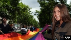 Activists carry a rainbow flag, the symbol of the gay rights movement, during a rally in Moscow.