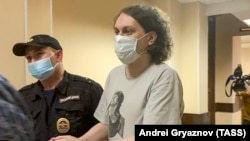 Yury Khovansky is escorted to a court hearing in St. Petersburg in June.