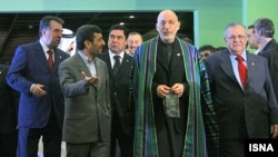 Iranian President Mahmud Ahmadinejad gestures as he speaks to Afghan President Hamid Karzai at an Economic Cooperation Organization summit this month in Tehran.