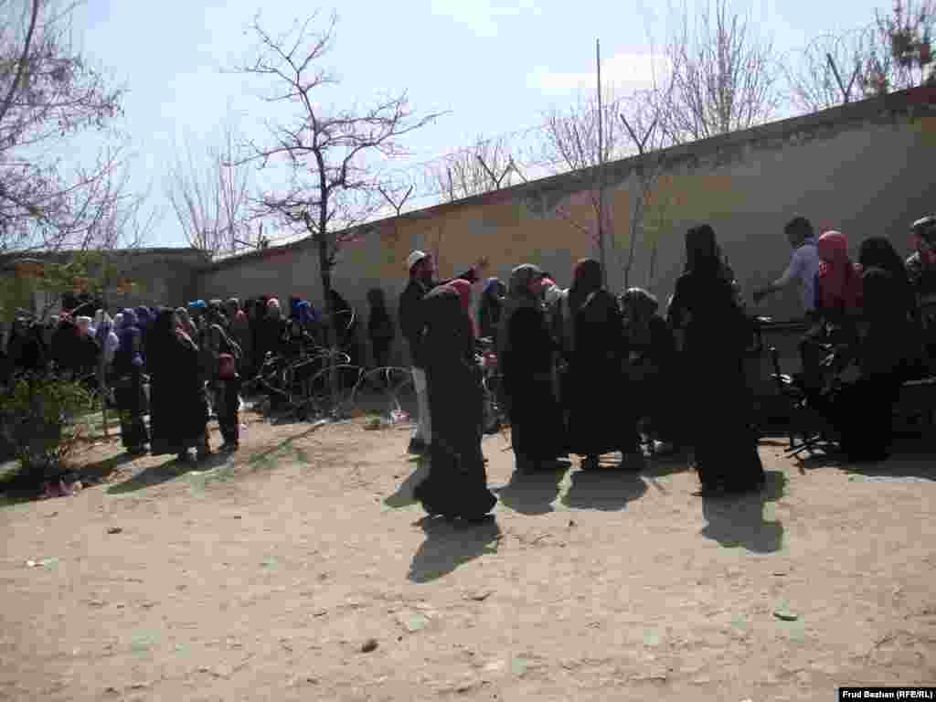 Women wait to get their cards at the voter-registration office in Karte Seh on April 1.