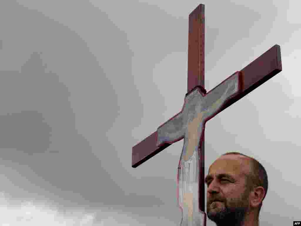 A Kosovo Serb holds up a cross as he attends a ceremony marking the Battle of Kosovo Polje in Gazimestan in 2010.