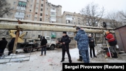 Members of the emergency services gather near a damaged apartment block after an apparent gas explosion in the town of Shakhty on January 14.