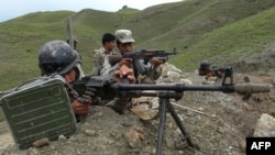 Afghan border policemen take positions on the border between Afghanistan and Pakistan in Goshta district of Nangarhar Province last month.