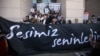 Supporters of world-renowned Turkish pianist Fazil Say stand behind a banner reading "Our voice is with you" during a protest held outside an Istanbul court, on October 18.