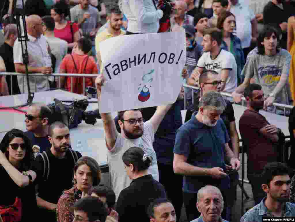 A sign with the portmanteau Gavnilov that combines the last name of Russian State Duma Deputy Sergei Gavrilov -- who sat in the Georgian parliamentary speaker&#39;s chair during a meeting of international lawmakers on June 20, angering the protesters -- and the word &quot;govno,&quot; which means crap. Demonstrators view Gavrilov as an ally of Putin and say he backs Russia&#39;s support for the breakaway regions of South Ossetia and Abkhazia. &nbsp;